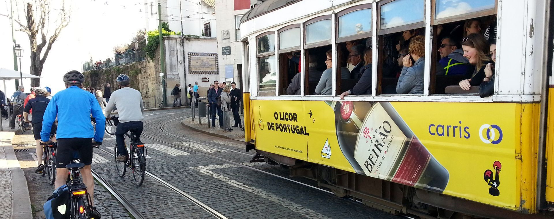 Radfahrer und gelbe Straßenbahn in der Stadt - Lissabon - Portugal